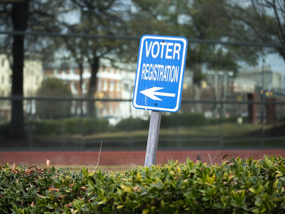 A sign for voter registration stands in Columbia, S.C., in 2024.