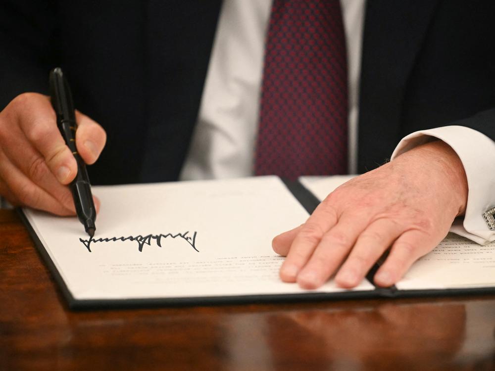 President Trump signs executive orders in the Oval Office of the White House in Washington, D.C., on Monday.