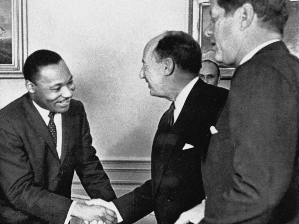 In this Dec. 17, 1962, photo, Ambassador Adlai Stevenson, the U.S. delegate to the United Nations, shakes hands with Martin Luther King Jr., president of the Southern Christian Leadership Conference at the White House with President John F. Kennedy at right. The meeting occurred as Kennedy met with members of the American Negro Leadership Conference on Africa.