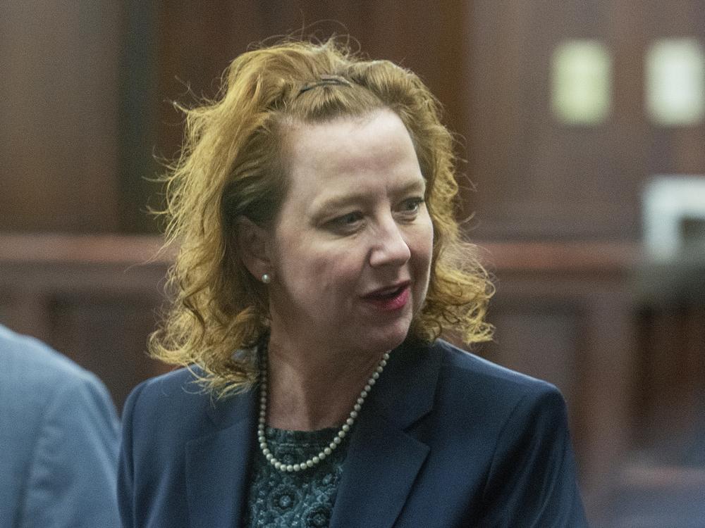 Former District Attorney Jackie Johnson speaks at the Glynn County Courthouse in Brunswick, Ga. last month. She goes on trial Monday for interfering with the police investigation into the shooting death of Ahmaud Arbery, the Black jogger chased and killed by three white men in February 2020. No arrests were made until months later, and only after video of the crime came out.