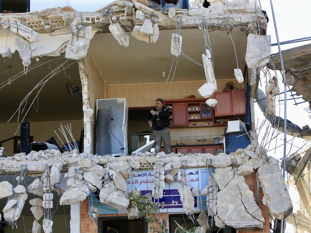 Lebanese citizens return to their homes heavily damaged by Israeli attacks, after Israeli forces withdraw from the area in An-Naqoura, Lebanon, on Thursday.