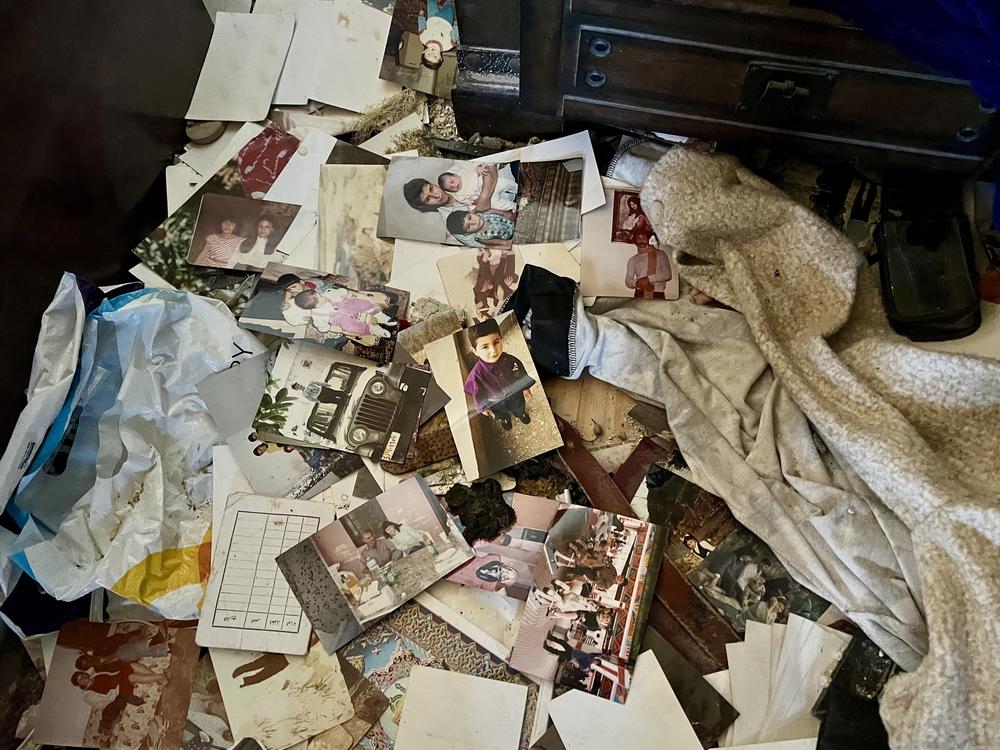 Scattered photographs and other items are seen on the floor of a home that was damaged during Israel's war with Hezbollah, in An-Naqoura, Lebanon.