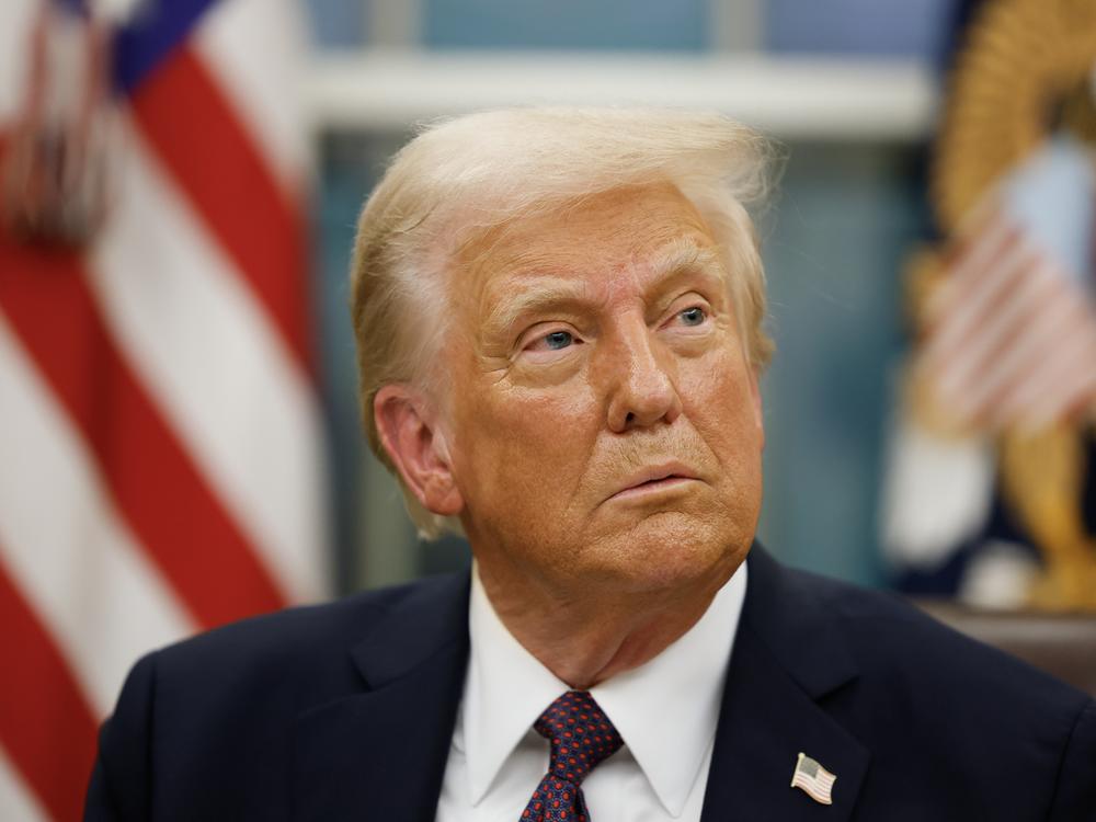 President Trump appears in the Oval Office following his inauguration on Monday.