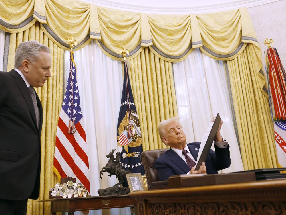 David Sacks, the White House 'czar' for artificial intelligence policy, speaks to President Trump as he signs a series of executive orders in the Oval Office on Jan. 23, 2025.