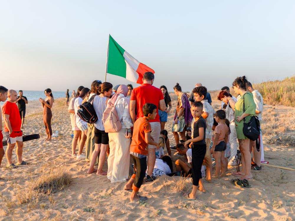 The hatching of endangered sea turtles attracts a small gathering of onlookers and volunteers on Mansouri Beach, in southern Lebanon, on Sept. 8, 2024.
