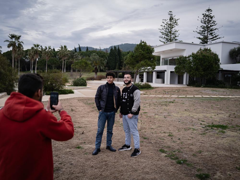 Syrians take photographs inside the grounds of the previously off-limits Assad summer villa outside Latakia.
