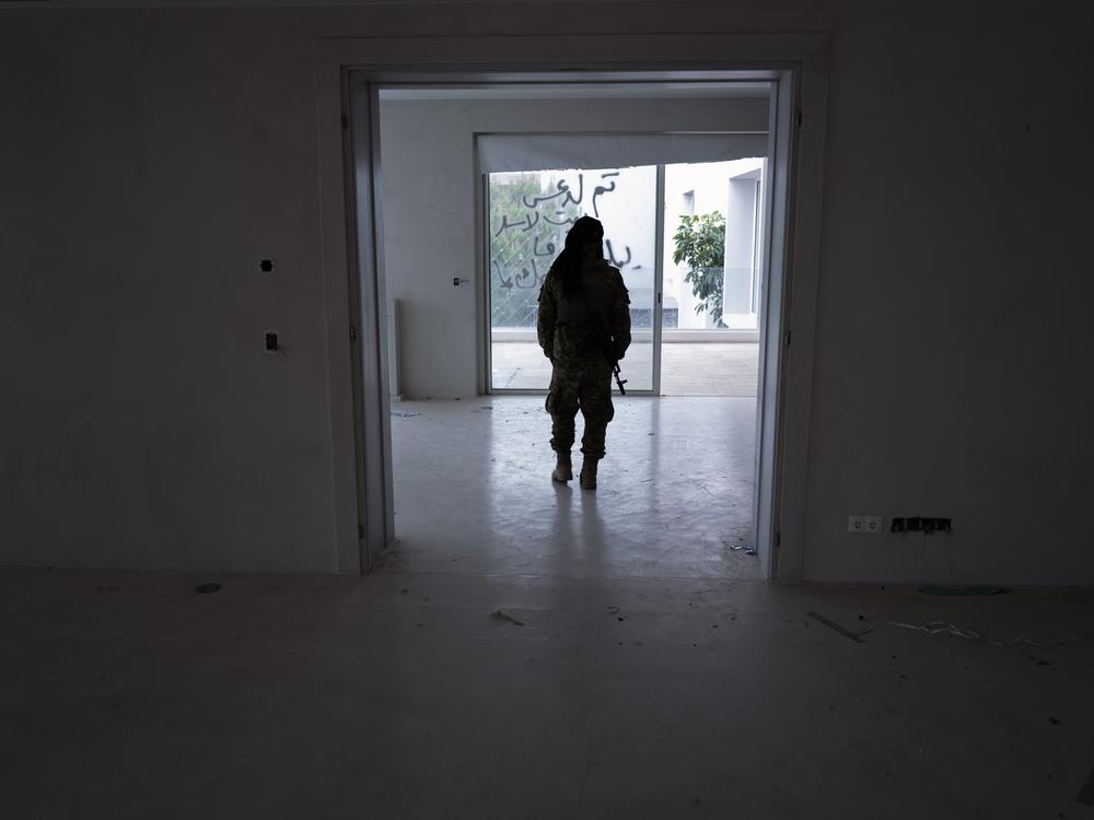 An HTS fighter seen inside the Assad family villa outside Latakia.