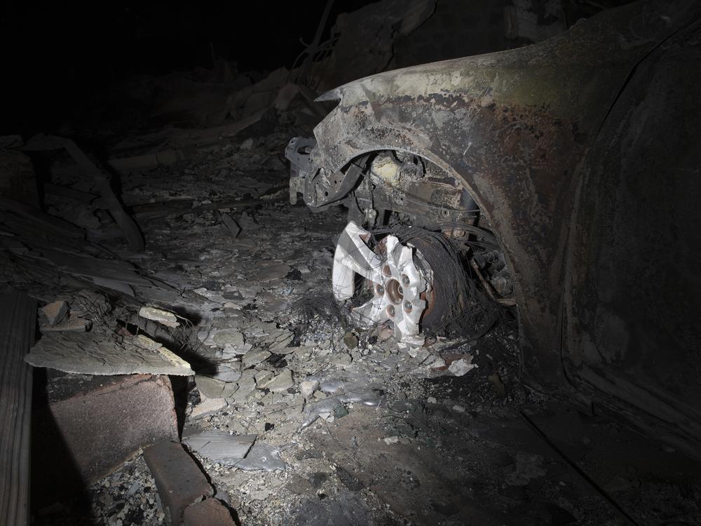 A mangled wheel well is seen after the Eaton Fire engulfed parts of Altadena. Pedro still has a hard time believing his home, let alone his community, could have gone through this.