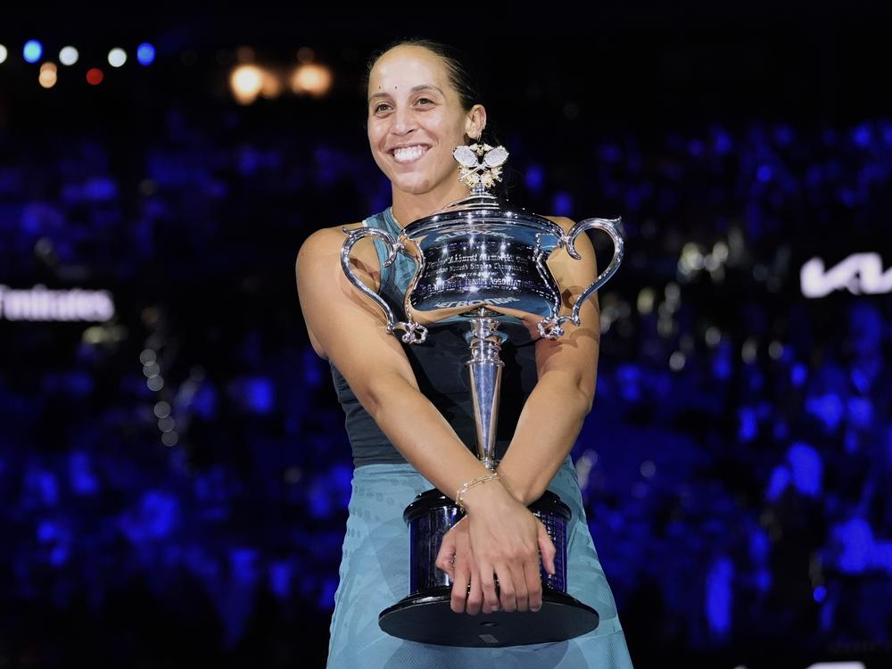 Madison Keys of the U.S. hugs the Daphne Akhurst Memorial Cup after defeating Aryna Sabalenka of Belarus in the women's singles final at the Australian Open tennis championship in Melbourne, Australia, Saturday, Jan. 25, 2025.