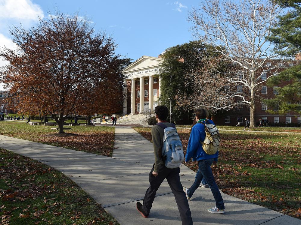 Students walk across the campus of the University of Maryland. A new round of data shows that college enrollment in the U.S. has surpassed pre-pandemic levels.
