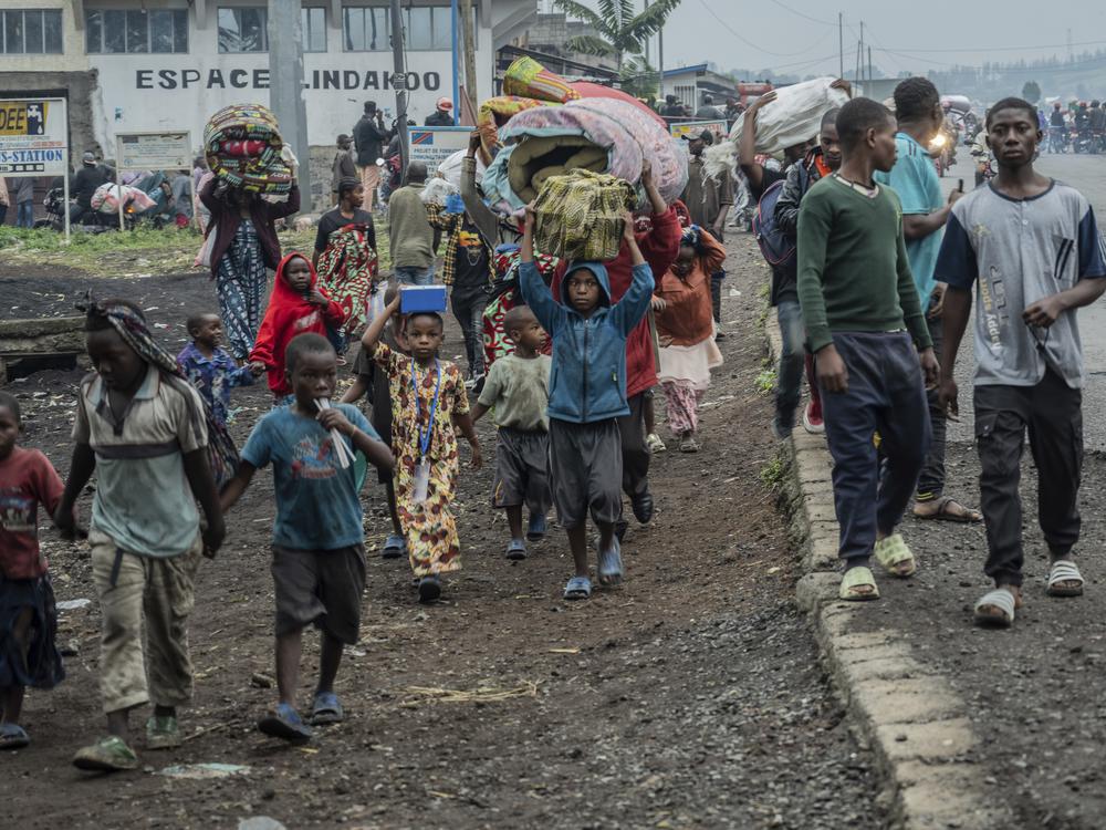 People displaced by the fighting with M23 rebels make their way to the center of Goma, Democratic Republic of the Congo, Sunday, Jan. 26, 2025.