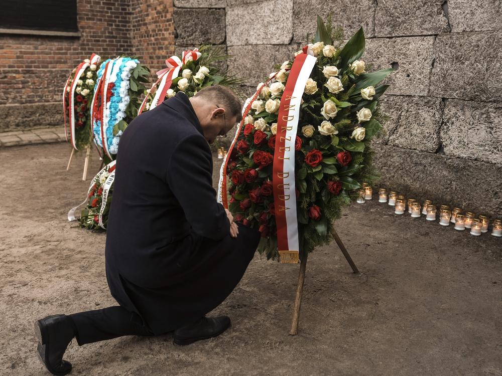 Polish President Andrzej Duda kneels in front of the Death Wall at the Auschwitz-Birkenau former Nazi German concentration and extermination camp, during a ceremony in Oswiecim, Poland, Monday, Jan. 27. 2025.