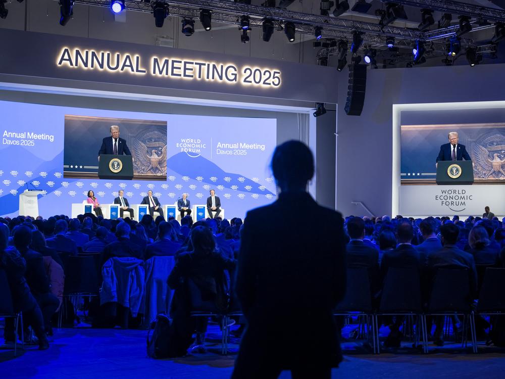 President Trump appears on a large screen during his address by video conference at the World Economic Forum's annual meeting in Davos, Switzerland, on Jan. 23.