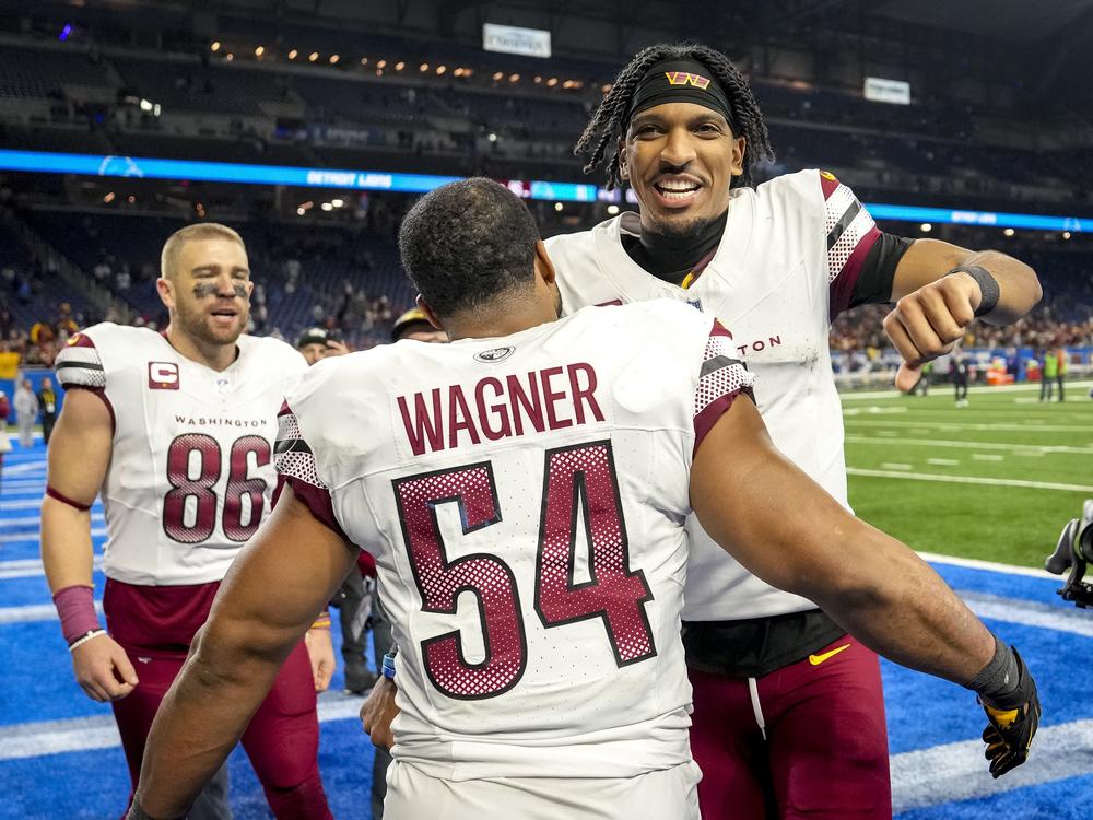 Jayden Daniels celebrates with Washington Commanders teammates Zach Ertz and Bobby Wagner after defeating the Detroit Lions in the NFC Divisional Playoff on Jan. 18, 2025 in Detroit.
