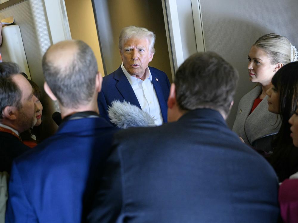 President Trump speaks with the press aboard Air Force One en route to Miami on Saturday.
