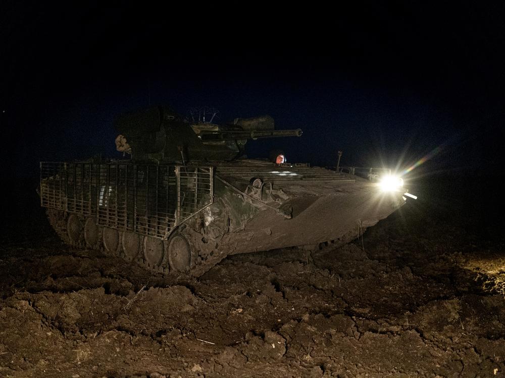 A BMP-1 idles near a farm field before heading to target Russian positions across the Dnipro River. The weapon system dates back to the Soviet era but has been upgraded with a better cannon and modern optics and software to allow night raids.