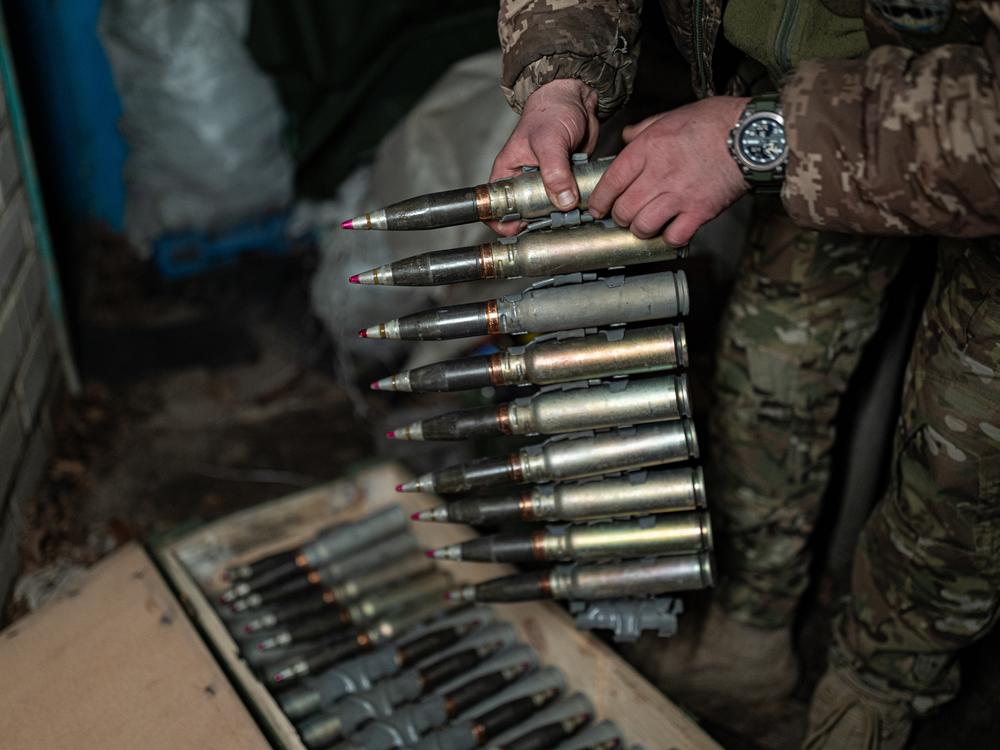 Grizzly, leader of the BMP-1 crew, prepares to load 30 mm shells into the infantry fighting vehicle's cannon.
