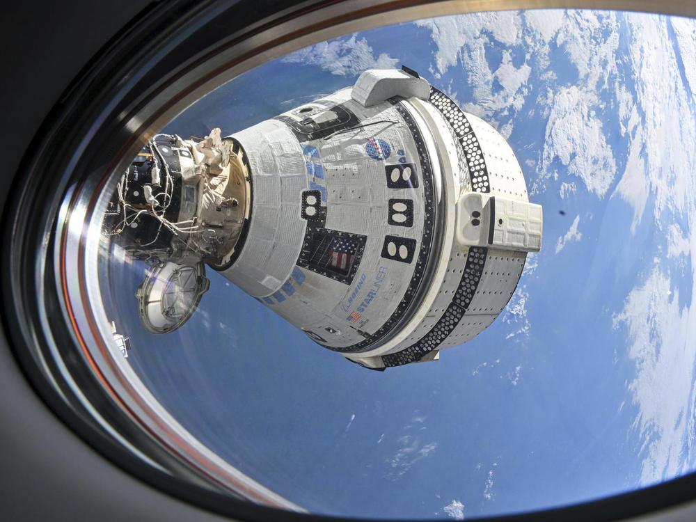 This image provided by NASA shows the Boeing Starliner capsule, which carried astronauts Butch Wilmore and Suni Williams to the International Space Station, docked on July 3, 2024, as seen from a window of SpaceX's Dragon Crew Dragon. The Starliner capsule returned to Earth empty in September after a series of technical problems.