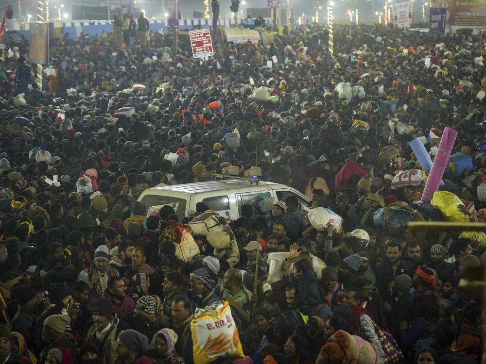 An ambulance moves in the middle of a crowd of Hindu devotees gathered for a holy dip by the banks of the Sangam, the confluence of the Ganges, the Yamuna and the mythical Saraswati rivers, on Mauni Amavasya' or new moon day during the Maha Kumbh festival in Prayagraj, Uttar Pradesh, India on Wednesday.