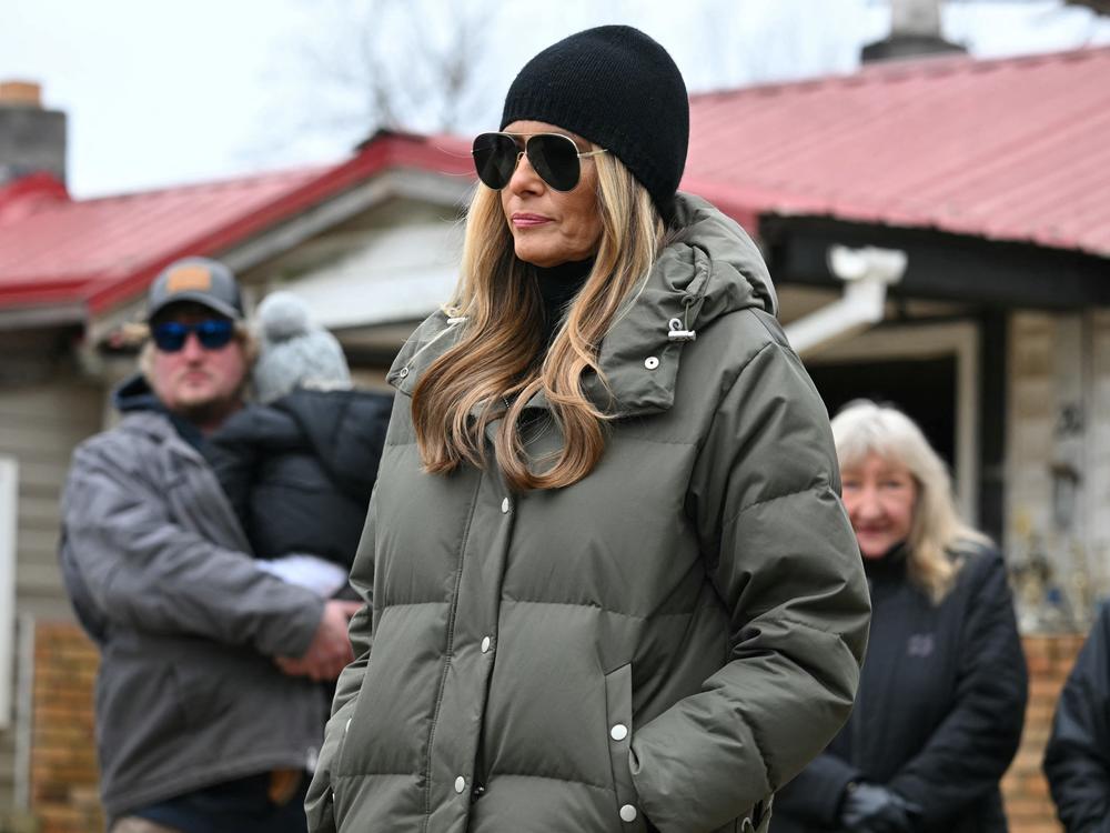 The first lady listens to President Trump speak as he surveys recovery efforts in a neighborhood affected by Hurricane Helene in Swannanoa, N.C., on Jan. 24.