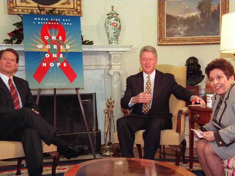 President Bill Clinton and Vice President Al Gore (L) sit in the Oval Office of the White House with Health and Human Services Secretary Donna Shalala.