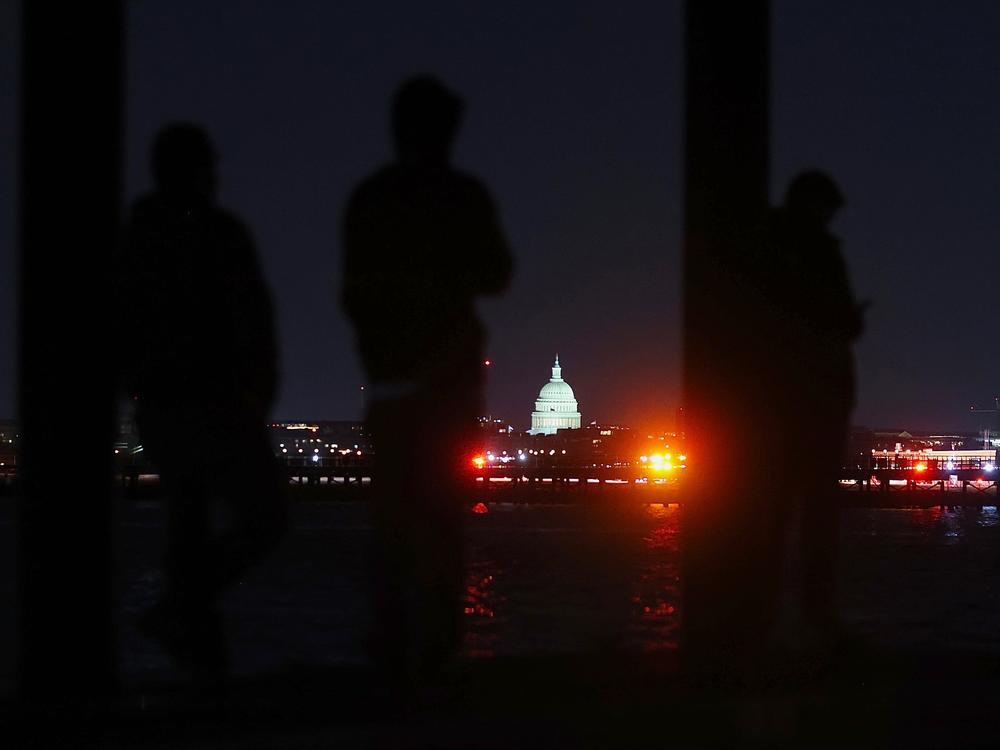 People gathered to watch search efforts on the Potomac River.