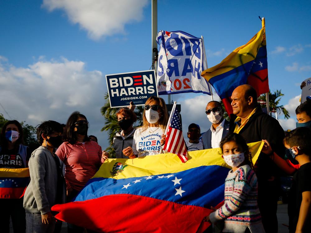 Venezuelans gather to celebrate the granting of a temporary protected status (TPS) by US President Joe Biden in front of El Arepazo restaurant in Miami, Fla., on March 9, 2021.