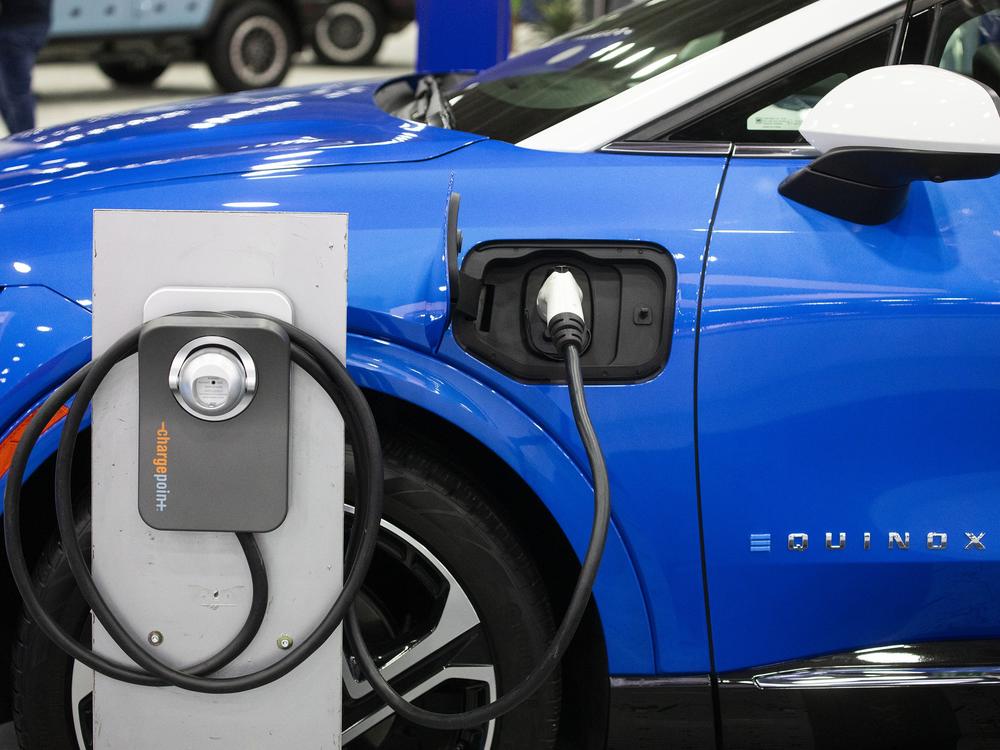 A Powering Michigan display about electric vehicles and charging is shown at the 2025 Detroit Auto Show on Jan. 10. The Biden administration promoted electric vehicles through a range of policies, which the Trump administration is in the process of reversing.