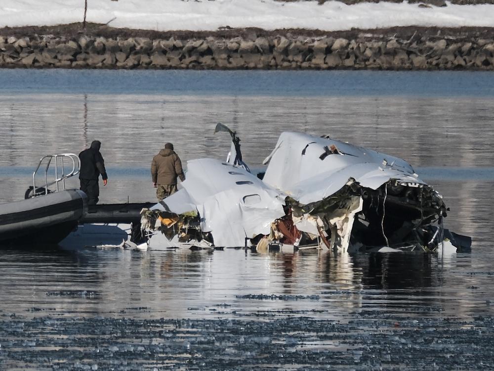 First responders search the crash site of American Airlines Flight 5342 along the Potomac River near Ronald Reagan National Airport in Arlington, Va., on Thursday.
