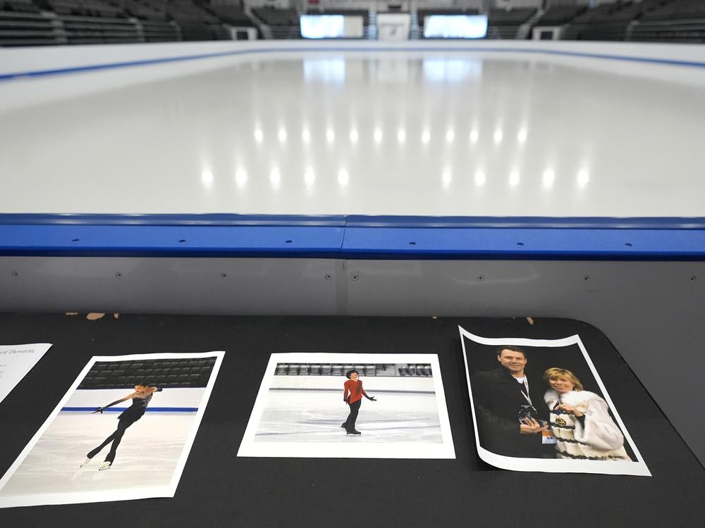 Photographs of aircraft crash victims from the Skating Club of Boston are displayed rink-side on Thursday in Norwood, Mass. From left: Skater Jinna Han, skater Spencer Lane and coaches Vadim Naumov and Evgenia Shishkova.