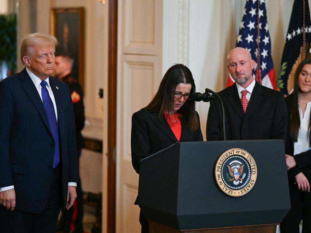 President Trump looks on as Allyson Phillips, mother of Laken Riley, speaks before Trump signed the Laken Riley Act in the East Room of the White House on Jan. 29.