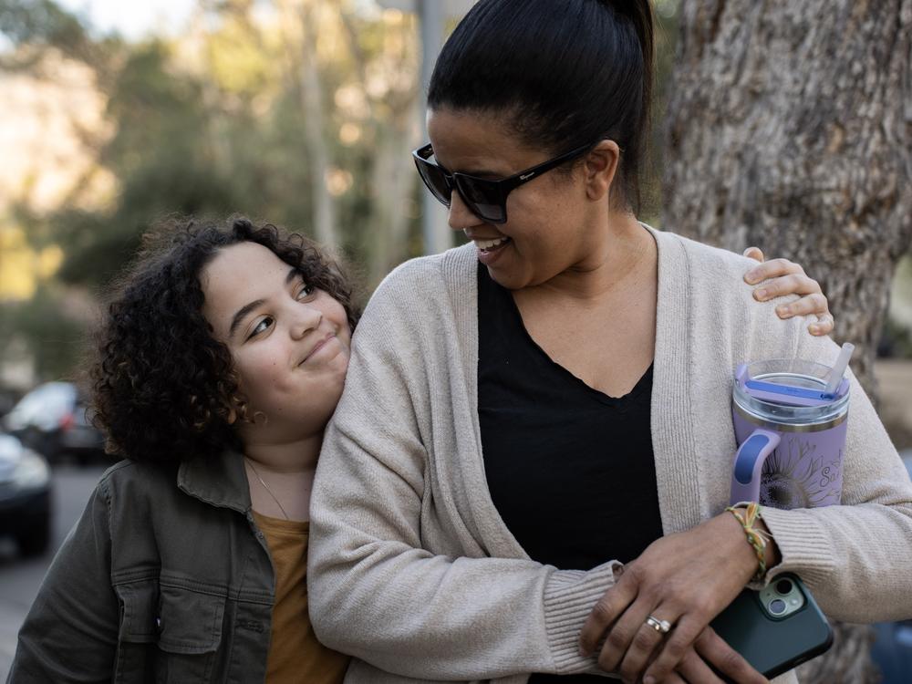 Indie Roffman (left) and her mom, Sandy Roffman, outside the school.
