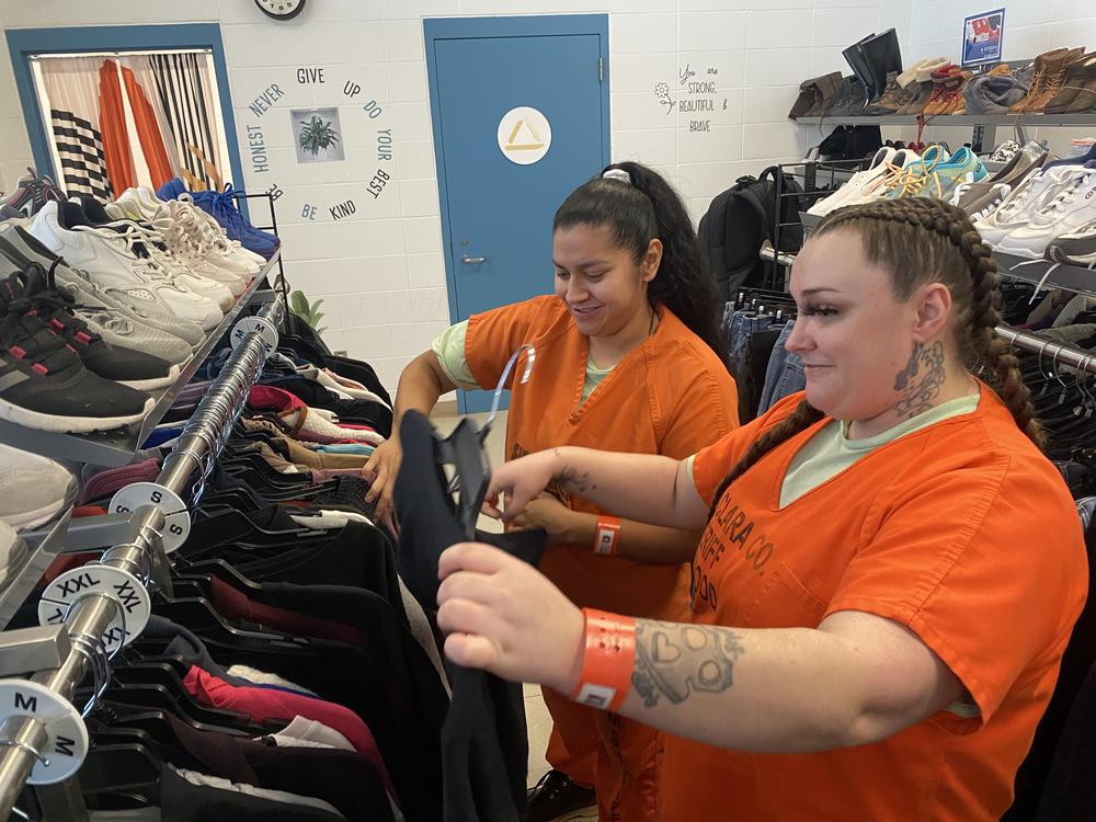 Blanca Hernandez (right) helps Jessica Lemos pick out clothes at the Elmwood Correctional Facility's Goodwill store on Jan. 9, 2025. Both are employees at the store, which allows exiting inmates to choose two outfits.