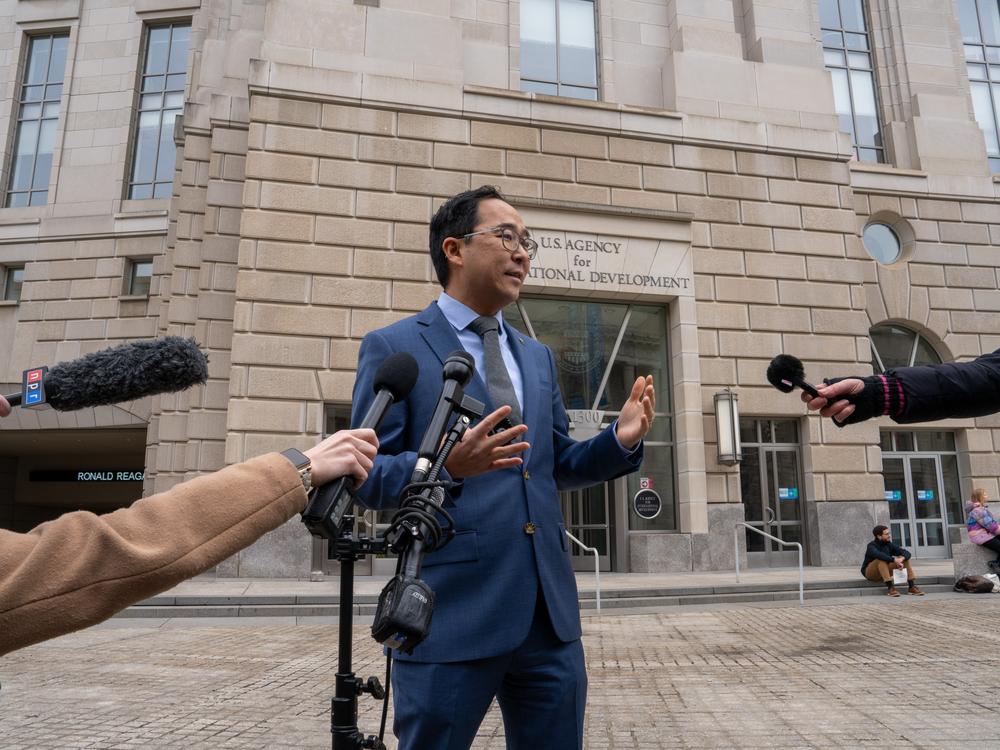 Democratic Sen. Andy Kim of New Jersey speaks outside the U.S. Agency for International Development Monday.