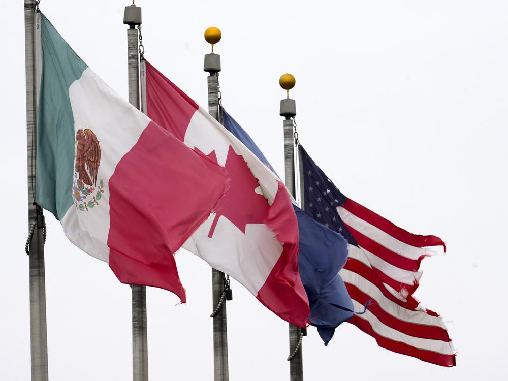 The flags of Mexico, Canada and the United States are shown near the Ambassador Bridge, Monday, Feb. 3, 2025, in Detroit.
