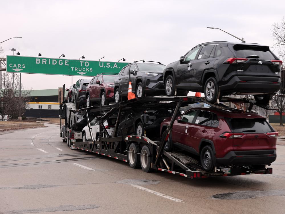 A car hauler carries Toyota RAV4 vehicles as it enters to cross the Ambassador Bridge in Windsor, Ontario to go to Detroit, Michigan on February 3.