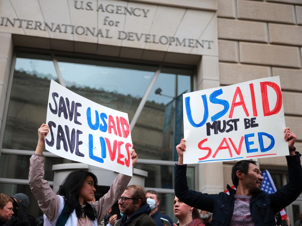 Protesters gather outside of USAID headquarters in Washington, D.C., on Monday, after Elon Musk said his Department of Government Efficiency will shut down the foreign assistance agency.