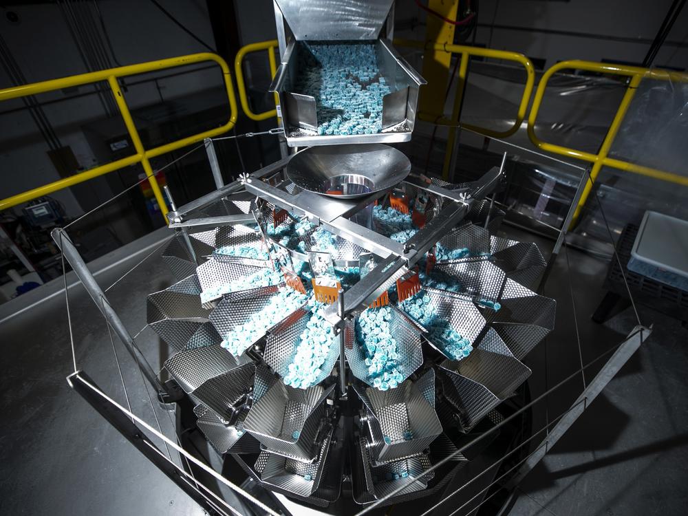 A machine doles out gummies for packaging in the Ripple Cannabis Co.'s Commerce City production facility.