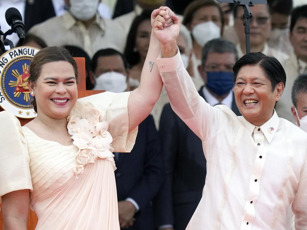 Philippine President Ferdinand Marcos Jr., center right, and Vice President Sara Duterte, daughter of former Philippine President Rodrigo Duterte, raise hands during the inauguration ceremony at National Museum on Thursday, June 30, 2022 in Manila.