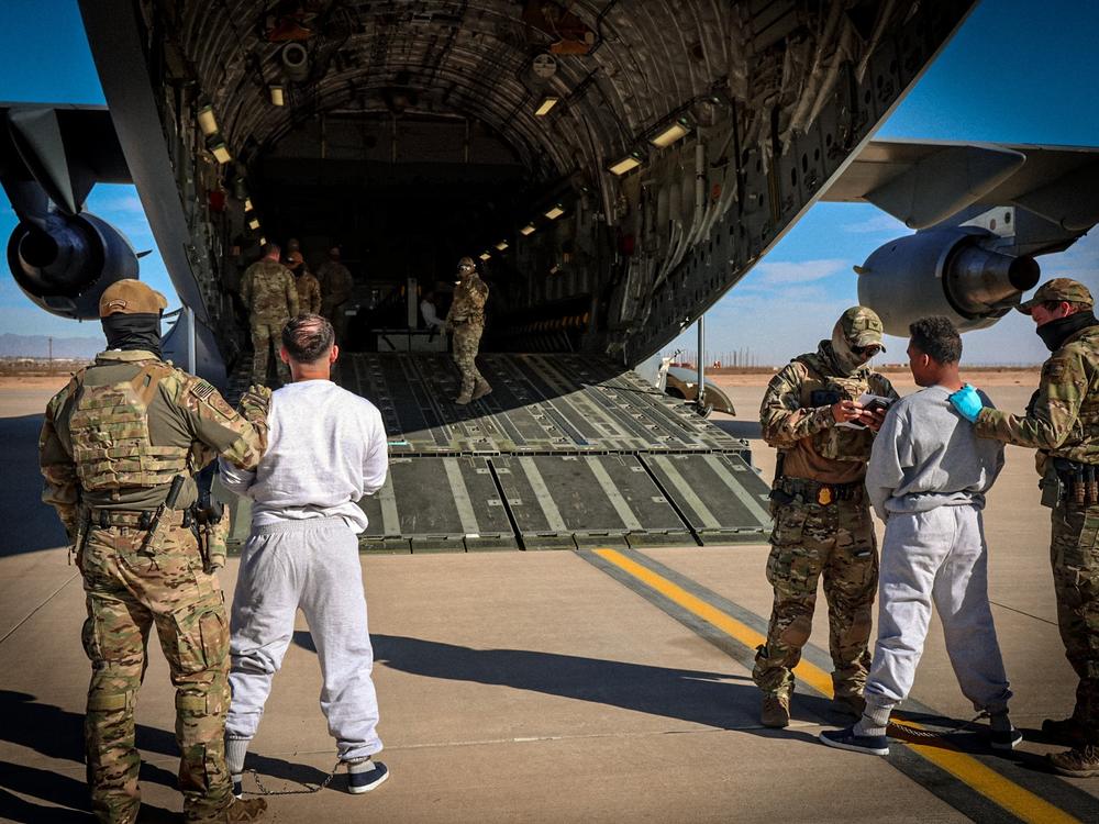 The Department of Homeland Security released photos of migrants as they boarded planes for Guantánamo Bay, Cuba.