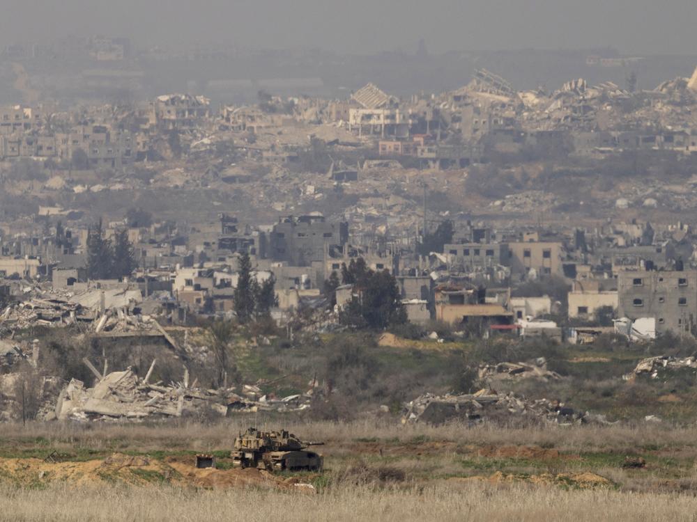 An Israeli tank stands in position in the northern Gaza Strip, as seen from the Israeli side of the border in southern Israel, Jan. 28.