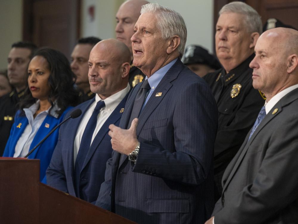 Nassau County Executive Bruce Blakeman, flanked by local police and federal officials, announces an agreement to 