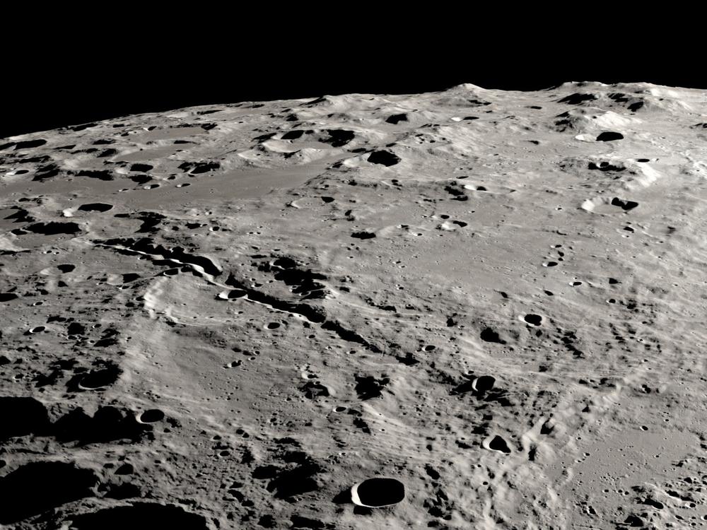 Two grand canyons on the moon radiating from the Schrödinger impact basin, from a view that looks obliquely across the lunar surface, like an astronaut in an approaching spacecraft.