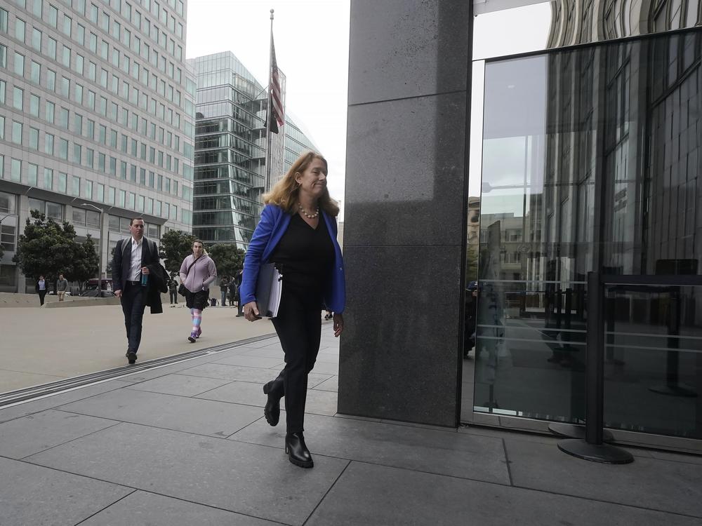 Attorney Shannon Liss-Riordan walks toward an entrance to a federal courthouse in San Francisco in December 2022. She is representing thousands of former Twitter employees suing the company over severance and other issues.