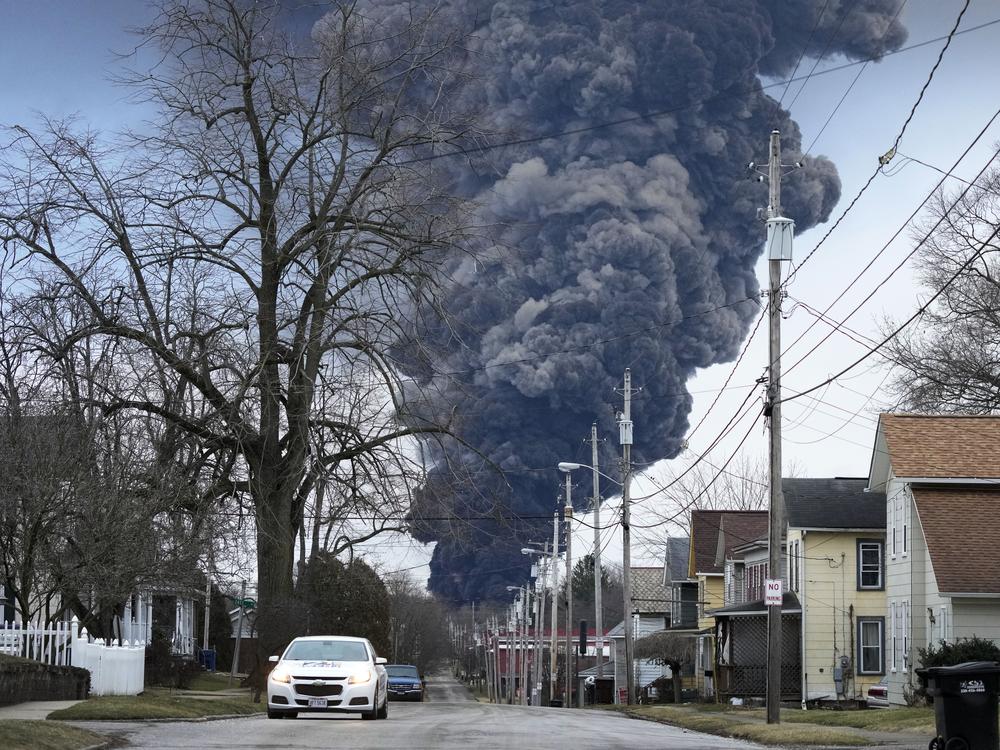 A black plume rises over East Palestine, Ohio, as a result of a controlled detonation of a portion of the derailed Norfolk Southern trains on Feb. 6, 2023.