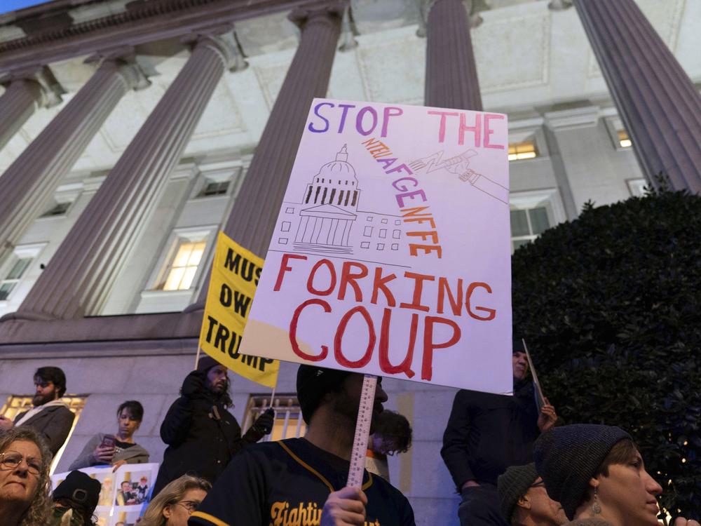 People protest during a rally against Elon Musk outside the Treasury Department in Washington, D.C., on Tuesday, Feb. 4, 2025.
