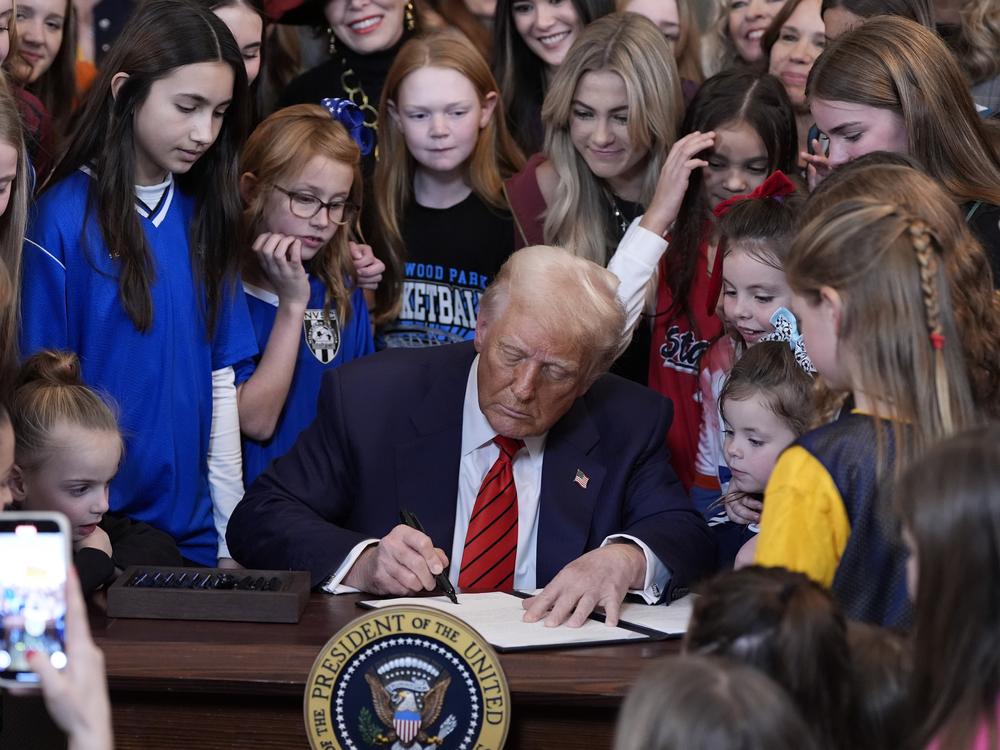 President Donald Trump signs an executive order barring transgender female athletes from competing in women's or girls' sporting events, in the East Room of the White House on Feb. 5.