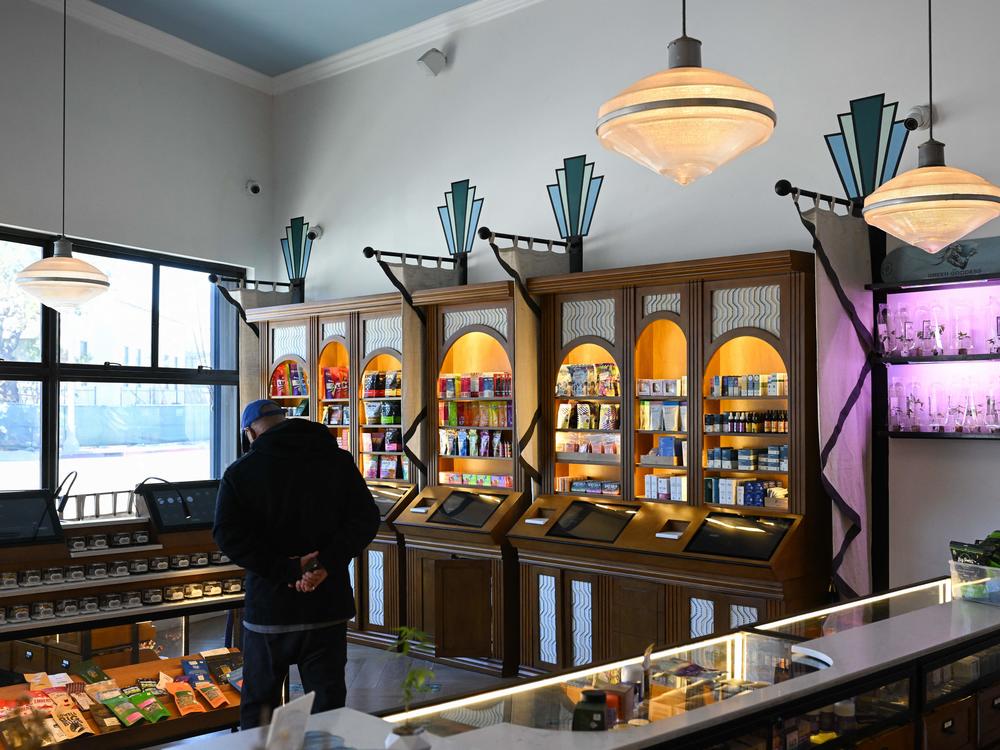 A customer browses products for sale at the Green Goddess Collective legal cannabis dispensary in the Venice neighborhood of Los Angeles, California.  State officials and many cannabis experts hope licensed shops will eventually displace the booming black market industry.