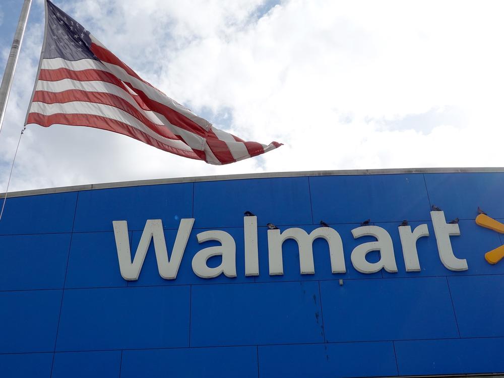 An American flag flies outside a Walmart store in Miami. In 2020, Walmart was one of many large U.S. companies that pledged to fight racism and increase internal diversity. But now it, Amazon, Facebook and many other companies are ending some of those programs.