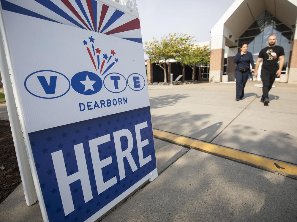 People leave a polling place where voters are casting their ballots during Michigan's early voting period on Oct. 29, 2024, in Dearborn, Mich.